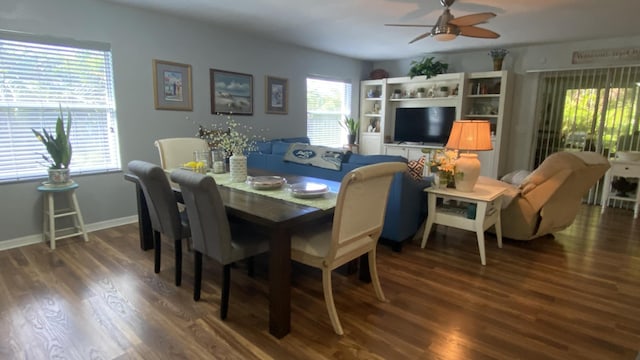 dining room with wood finished floors, a ceiling fan, and baseboards