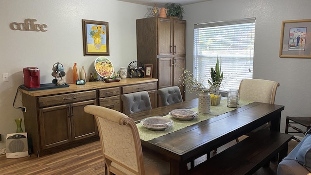 dining space with wood finished floors