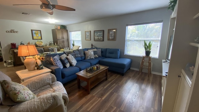 living area featuring a ceiling fan, baseboards, visible vents, and wood finished floors