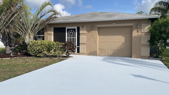 7 Los Lagos Ln, Port Saint Lucie, FL 34952 - view of front of home featuring concrete driveway, stucco siding, and a garage
