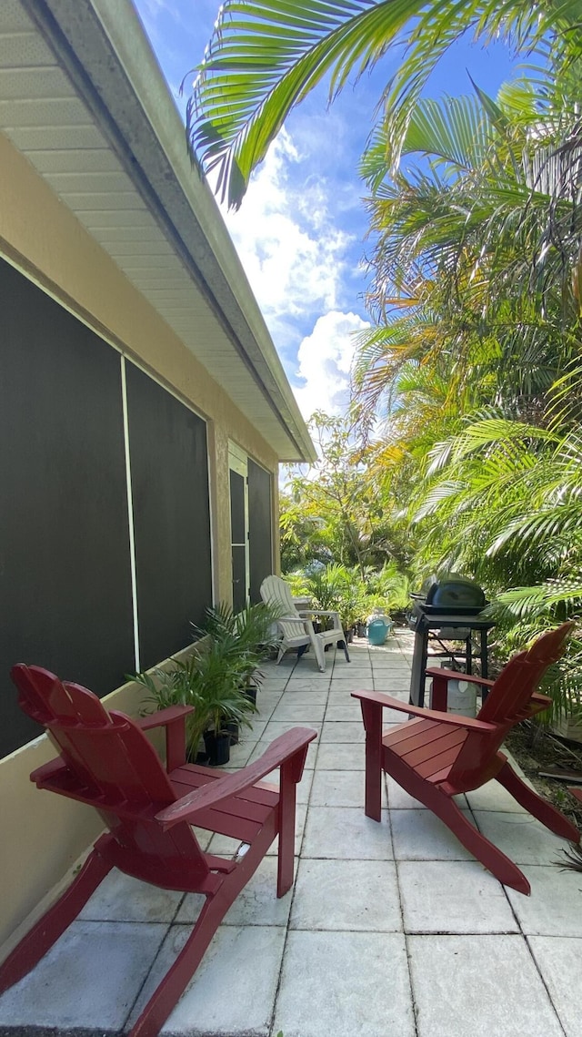 balcony with a patio area and a grill