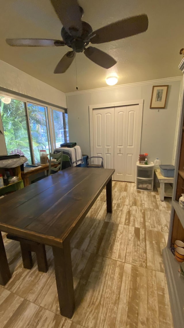 rec room with ornamental molding, ceiling fan, and light wood finished floors