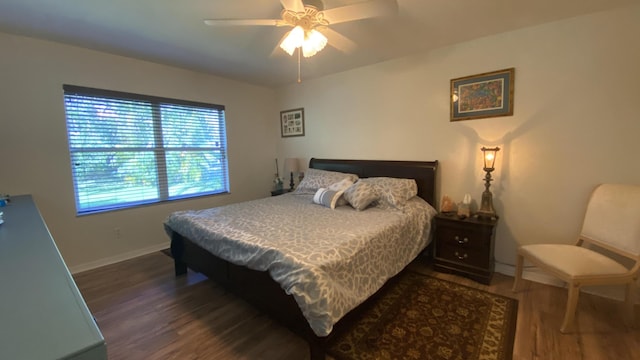 bedroom with ceiling fan, baseboards, and wood finished floors