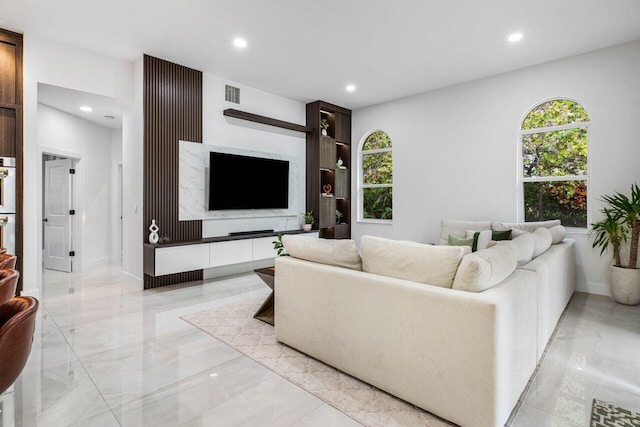 living room with recessed lighting, marble finish floor, and visible vents