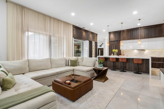 living room featuring marble finish floor and recessed lighting