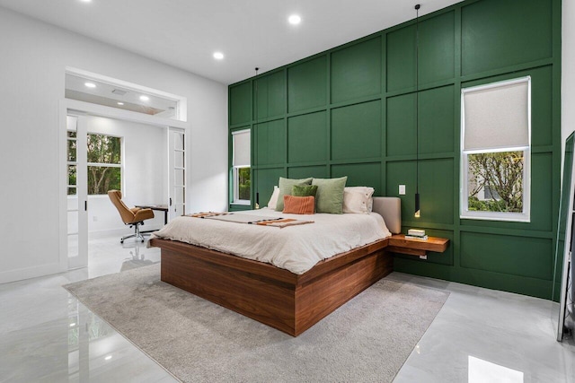 bedroom featuring french doors, recessed lighting, and a decorative wall