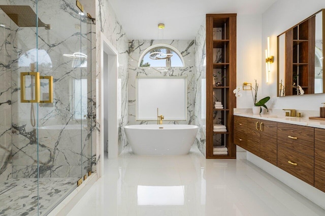 bathroom featuring a freestanding bath, marble finish floor, a marble finish shower, and vanity