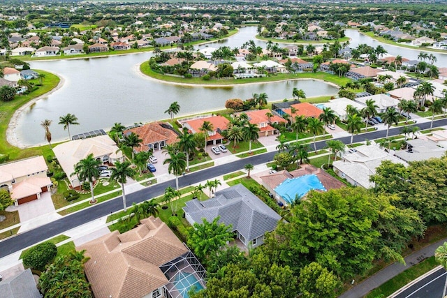 drone / aerial view featuring a water view and a residential view