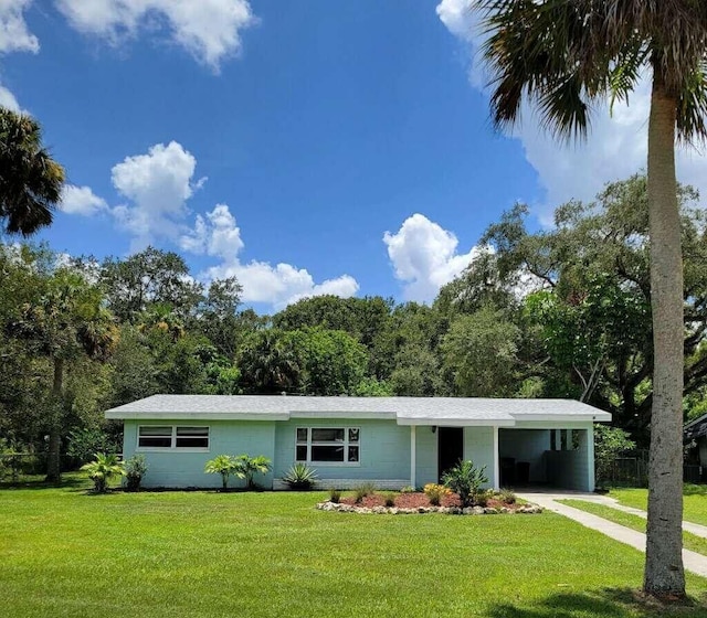 single story home featuring a carport, driveway, and a front lawn