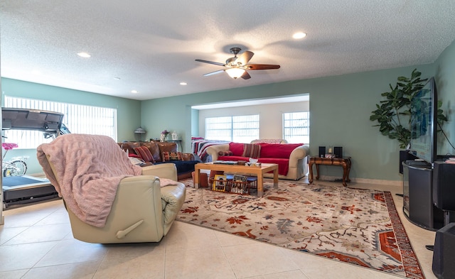 living room with light tile patterned flooring, plenty of natural light, and a textured ceiling