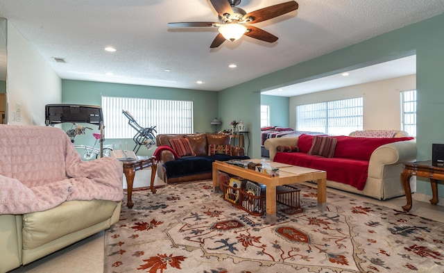 living room with recessed lighting, visible vents, ceiling fan, a textured ceiling, and tile patterned floors