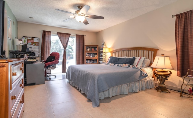 bedroom featuring a ceiling fan, a textured ceiling, and light tile patterned floors