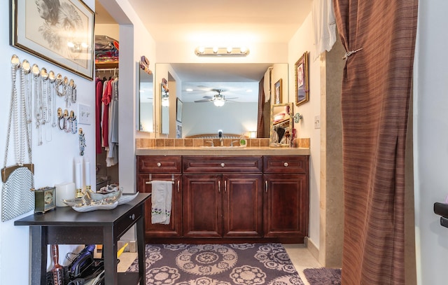 full bathroom with tile patterned flooring, a spacious closet, and vanity