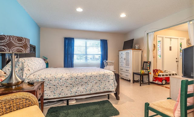 bedroom with recessed lighting, light tile patterned flooring, and a textured ceiling