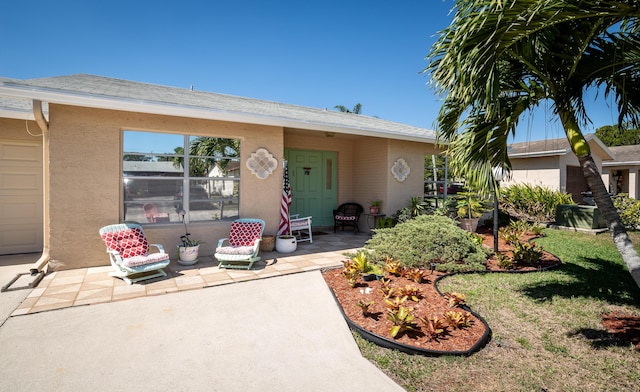 view of front of home with a patio and stucco siding