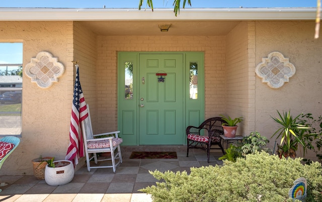 doorway to property with brick siding