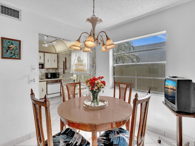 dining room featuring visible vents, a textured ceiling, and light tile patterned floors