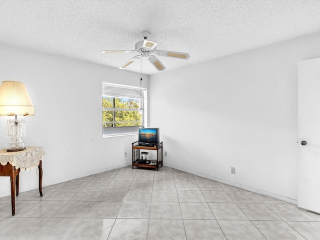 unfurnished room featuring ceiling fan and a textured ceiling