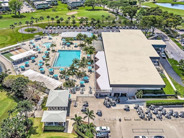 birds eye view of property with view of golf course and a water view