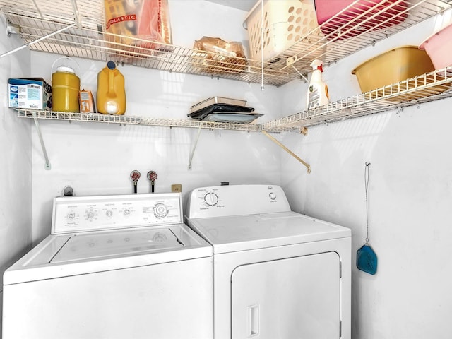 washroom with washing machine and dryer and laundry area