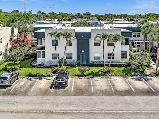 view of property featuring uncovered parking