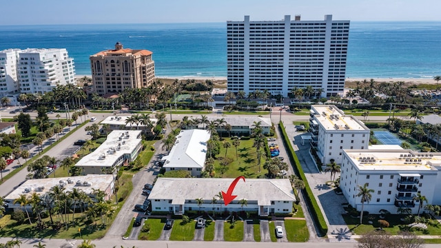 drone / aerial view featuring a view of the beach and a water view