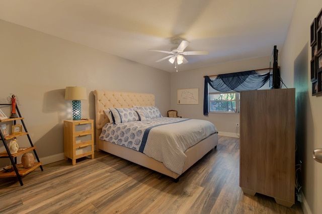 bedroom featuring ceiling fan, wood finished floors, and baseboards