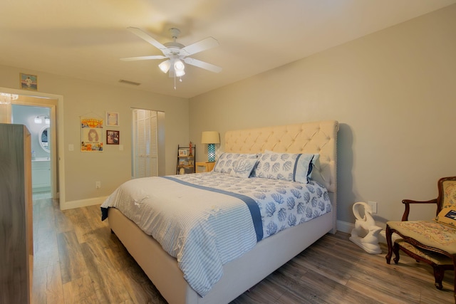 bedroom with baseboards, a closet, visible vents, and wood finished floors