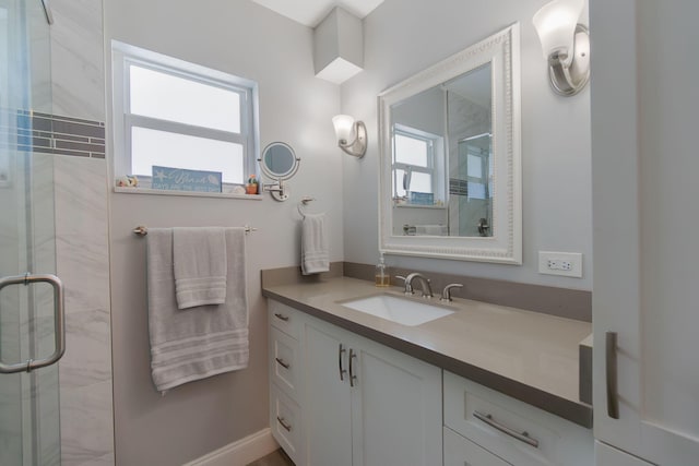 bathroom featuring a stall shower and vanity