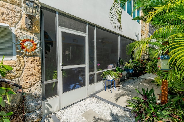 view of patio with a sunroom