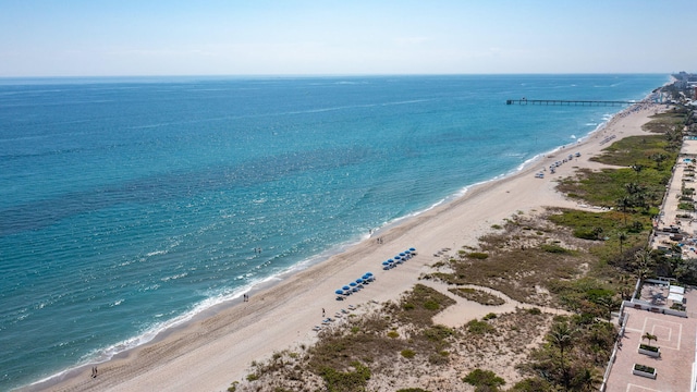 birds eye view of property featuring a view of the beach and a water view