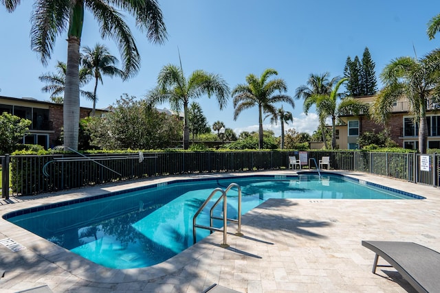 pool featuring a patio area and fence