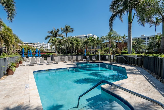 pool featuring a patio area and fence