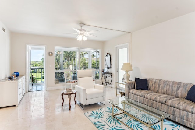 living area with light tile patterned floors, a ceiling fan, visible vents, and a wealth of natural light