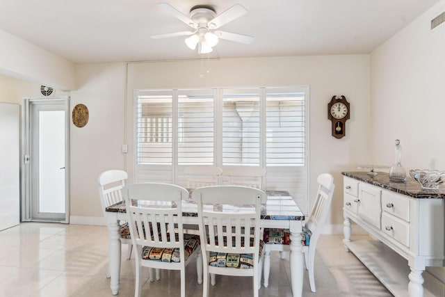 dining space featuring light tile patterned floors, baseboards, visible vents, and a ceiling fan