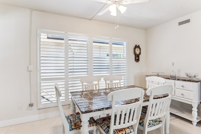 dining room featuring light tile patterned floors, visible vents, and a ceiling fan