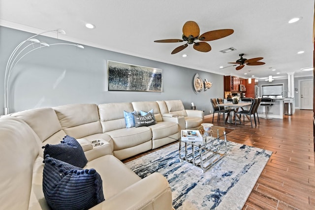 living room featuring recessed lighting, visible vents, crown molding, and wood finished floors