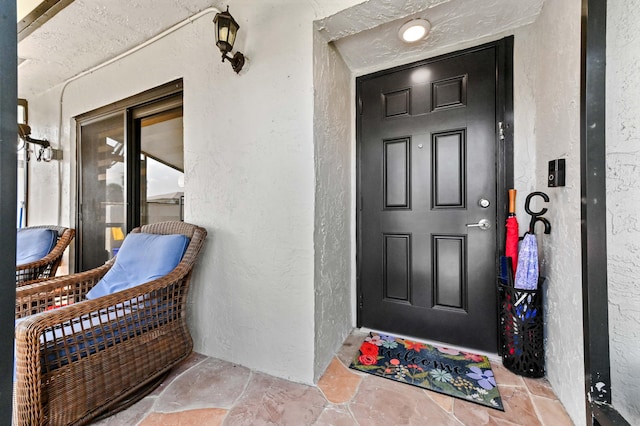 property entrance with stucco siding