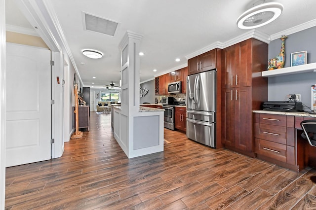 kitchen with dark wood finished floors, crown molding, light countertops, visible vents, and appliances with stainless steel finishes