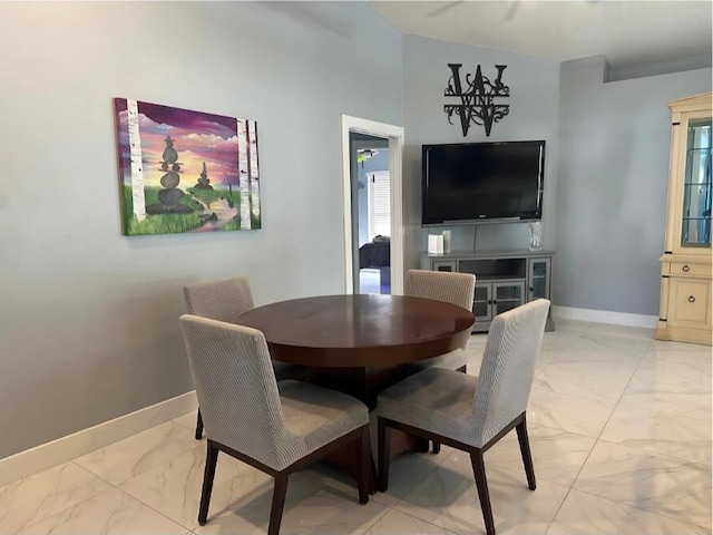 dining room with marble finish floor and baseboards