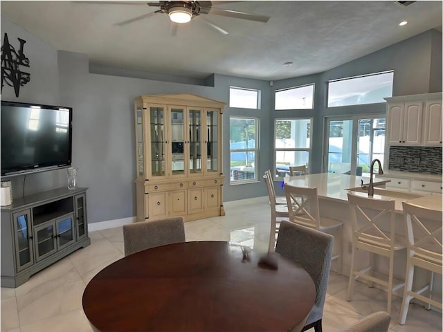 dining space with a ceiling fan, recessed lighting, a wealth of natural light, and baseboards