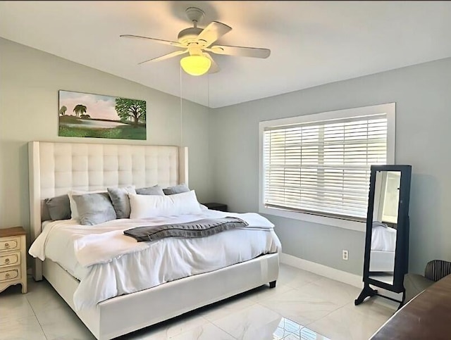 bedroom with lofted ceiling, ceiling fan, and baseboards