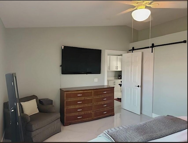 bedroom with lofted ceiling, marble finish floor, a barn door, and a ceiling fan