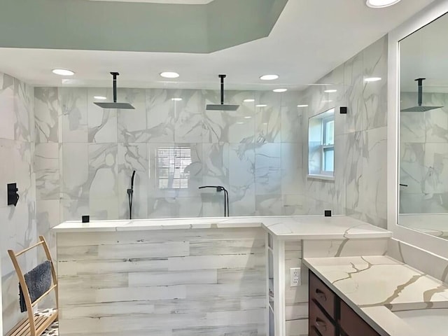 full bathroom featuring a marble finish shower, vanity, and recessed lighting