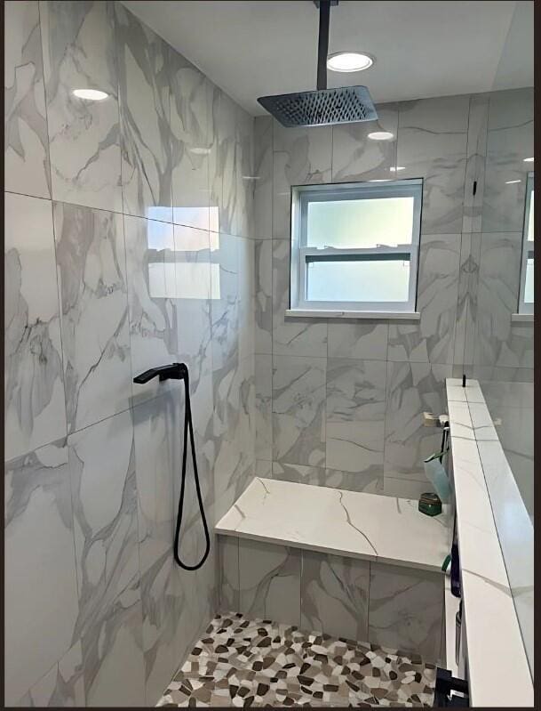 full bath featuring a marble finish shower