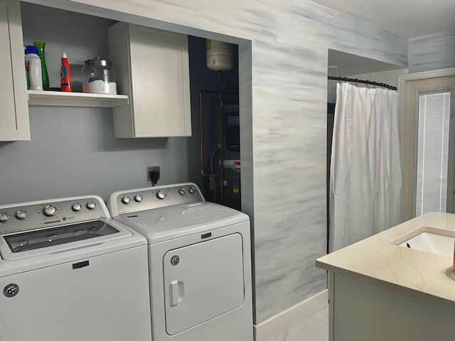 clothes washing area featuring laundry area, washer and clothes dryer, baseboards, and marble finish floor