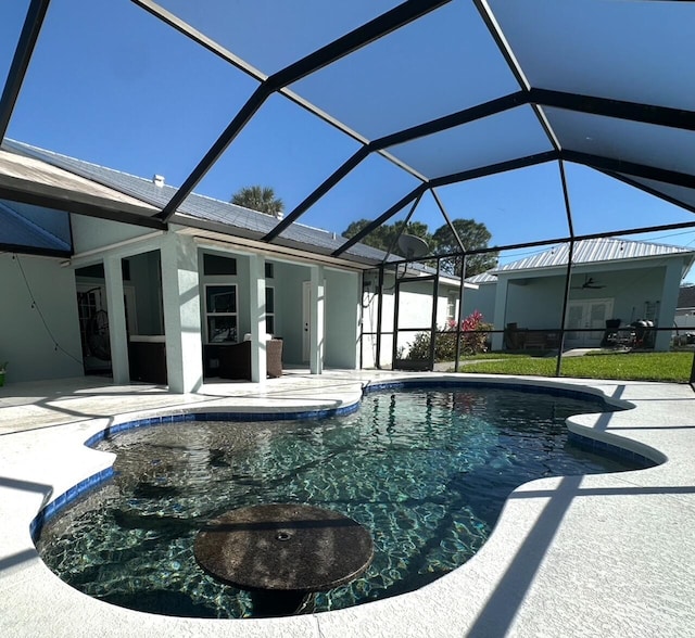 pool with glass enclosure and a patio