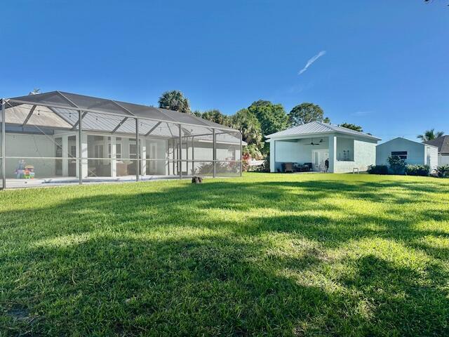 view of yard with glass enclosure