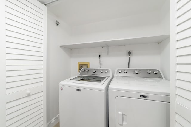 clothes washing area with washing machine and dryer and laundry area