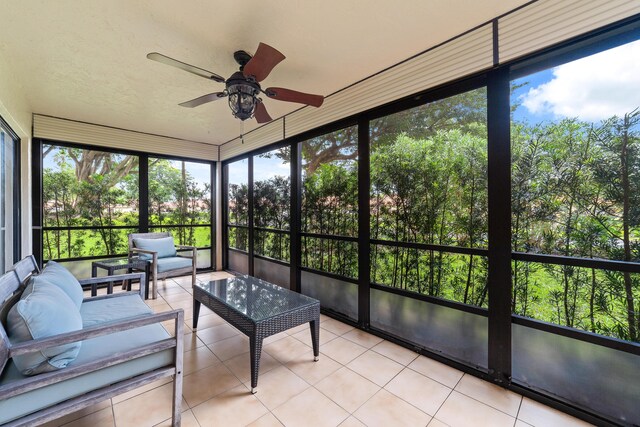 sunroom featuring a ceiling fan